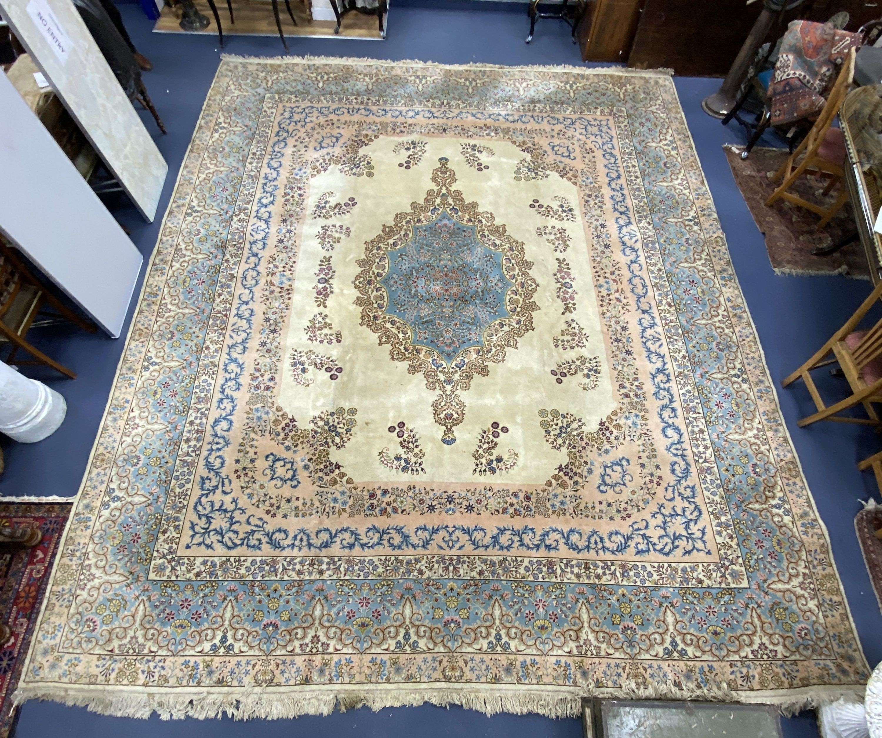 A large Kirman ivory ground carpet, 500 x 410cm